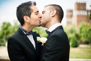 Portrait of Gay Couple kissing after getting married