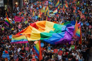 Istanbul, Turkey - June 30, 2013: Thousands of revelers joined for the 11th annual Gay Pride Pride in Taksim, Istanbul showing off a multitude of colorful flags and placards calling for equal rights and justice for LGBT related crime. There were also small protests for other causes.